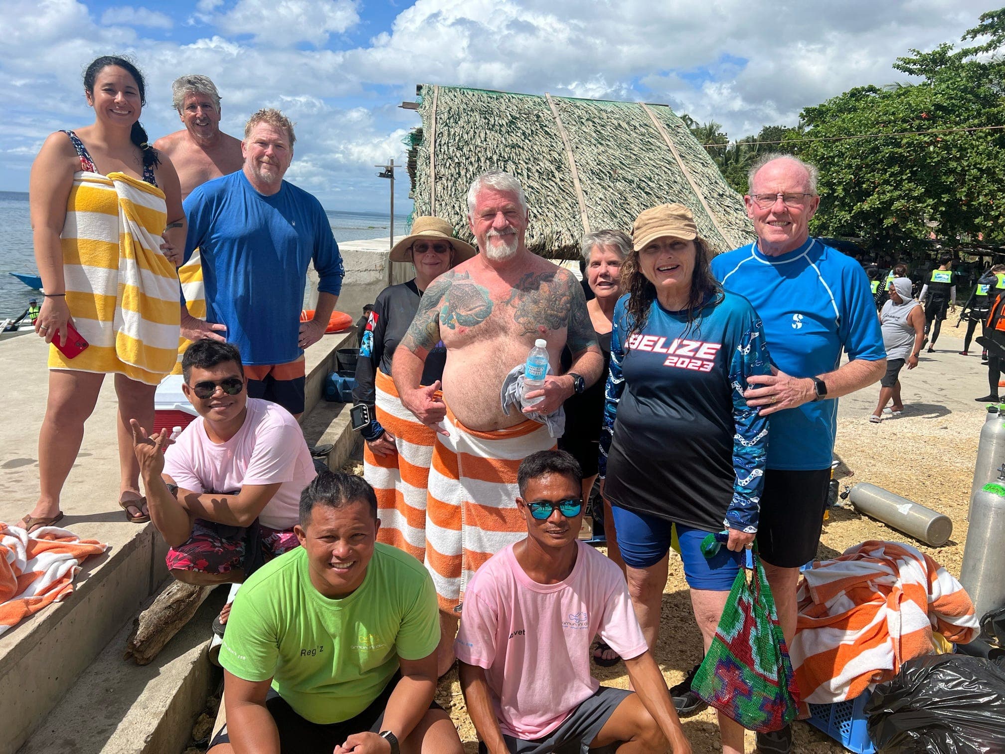 SXT travellers and local dive guides gathered on the beach after a dive in the Philippines